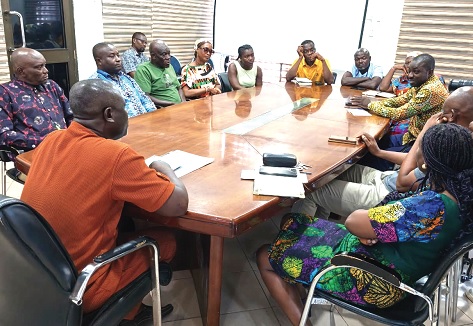 Freeman Tsekpo (left), MCE of Ashaiman, interacting with members of the committee