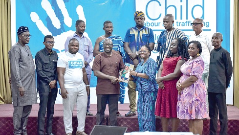 Alexander Mar Kekula (4th from left), National Director, SOS Children’s Villages Ghana, presenting the communique to Freda Faah (4th from right), Director in charge of Budget at the Minister of Local Government, Chieftaincy and Religious Affairs