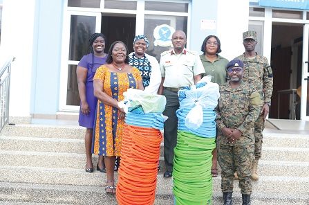 Abi Adatsi (2nd from left) with Col. Andrews Alipoe (middle), Course Director, KAIPTC, Lt. Col. Napoleon Tsatsu Avu-Tamakloe (right) and some staff of KAIPTC after the donation. Picture: BENEDICT OBUOBI