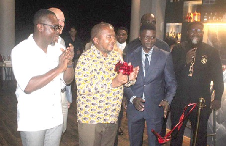 Thando Dalamba (middle), Deputy South African High Commissioner to Ghana; joined by Gilbert Abeiku Aggrey (left), Deputy CEO of GTA, and Nana Kwame Oteng-Gyasi (right), the Director of Anthonian Suites, to cut the tape to inaugurate Anthonian Suites (inset)