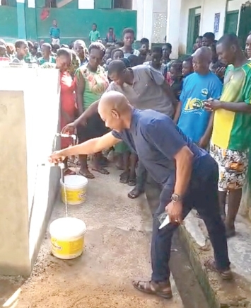 Shariff Tayib, CEO of Hatch House Foundation, and Eric Kwaku Foh, assembly member for Affutuakwa Electoral Area, fetching water from the system