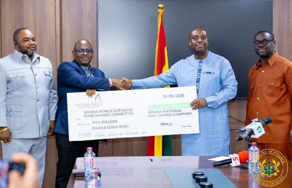 Ghana Gas Deputy CEO Rene Nelson presenting cheque to Deputy Finance Minister Thomas Nyarko Ampem