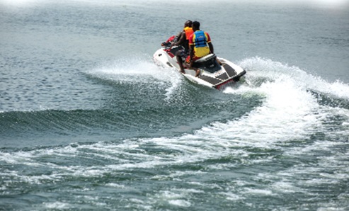 Visitors enjoying boat rides and jet skiing on the Volta River at Sogakope Beach Resort