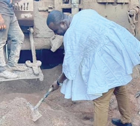 Prof. Seidu Mahama Alidu (with a shovel), MP for Tamale Central, cutting the sod for the borehole project