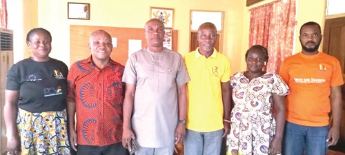 Dr Samuel Issaka Suraj (3rd from left) and Daniel Agbesi Latsu (3rd from right), Kadjebi District Director of the NCCE, with some staff