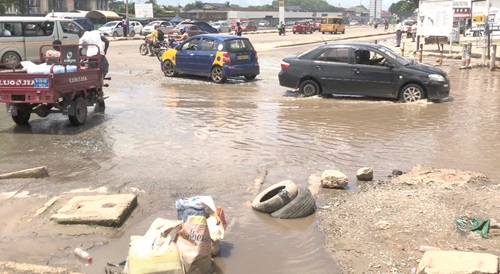 Drivers driving through flood waters at Dansoman Hansonic