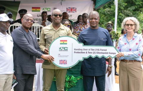 Dr Terri Sarch (right), acting Deputy British High Commissioner, and Dr Hugh C.A Brown (middle), Chief Executive of the Forestry Commission, displaying a dummy key to the forest protection camps. With them is Isaac Essien (right), Chairman, Forestry Commission Board, and other officials