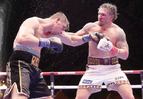 Oleksandr Usyk lands a hook to the face of Rico Verhoeven during the fight