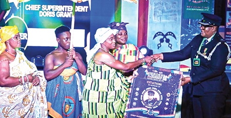 Chief Superintendent Doris Grant (right), Akosombo Divisional Commander of the Ghana Police Service, receiving a citation from Nana Dansoah Amamaah, Asamankese Kyidomhemaa, at the event