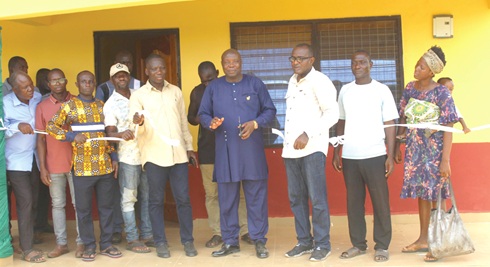 Isaiah Dordoe (4th from right), Nkwanta North DCE, and John Oti Bless (5th from right), MP for the area, cutting the tape to inaugurate the facility. Inset: The inside of the slaughterhouse