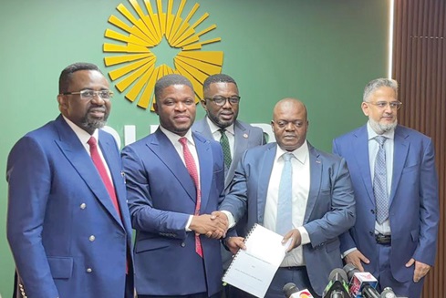 Sammy Gyamfi (2nd from left), CEO of GoldBod, and Eric Frimpong (2nd from right), CEO of Royal Ghana Gold Refinery Limited, displaying the signed document. With them is Dr Johnson Pandit Asiama (left), Governor, BoG, and other officials 