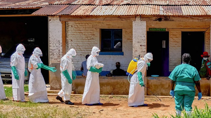 Red Cross volunteers are conducting safe burials for Ebola victims to prevent the virus from spreading