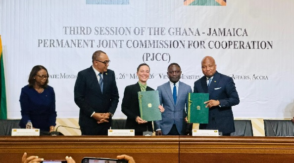 Representatives of the two countries exchanging the documents after the signing ceremony