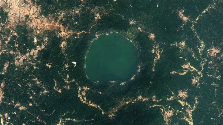 A more recent satellite photo, captured in 2024, shows that the level of gold mining around Lake Bosumtwe has increased significantly over the last decade. | Credit: NASA/Landsat