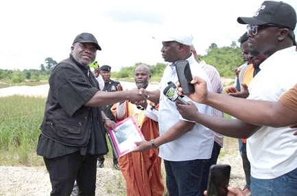Emmanuel Armah-Kofi Buah (right), Minister of Lands and Natural Resources, handing over the project site to Nana Kyeame Ampratwum, Lead Operational Director, RM Ecorestore