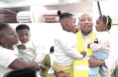 Samuel Okudzeto Ablakwa, Minister of Foreign Affairs, with two children who were on board the chartered flight from South Africa