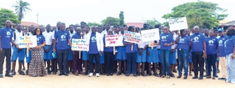 The organisers and some boys with placards to mark the day