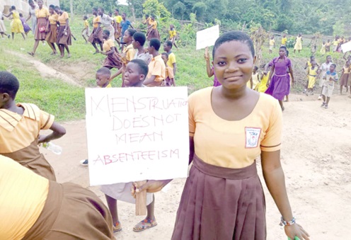 A schoolgirl bearing a placard drawing attention to the phenomenon