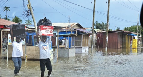 Some flood victims carrying their salvaged items to safety. Picture: DOUGLAS ANANE-FRIMPONG
