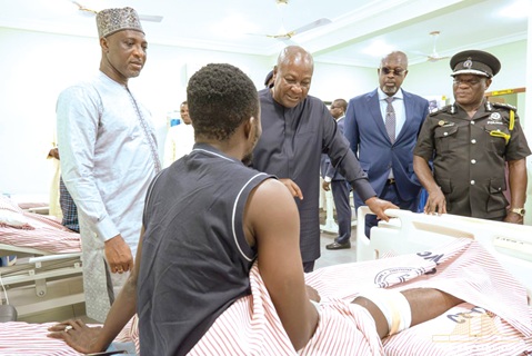 President John Dramani Mahama (3rd from right) in a chat with an injured officer admitted to the new block during the ceremony