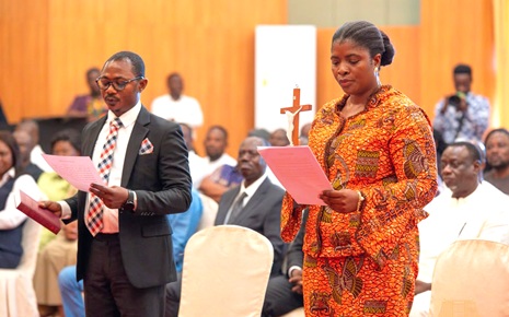 Emelia Afi Agbenyo (right) and Joseph Kwaku Asamoah (left), the two new appointed Deputy Commissioners of the Electoral Commission, taking their oath of office