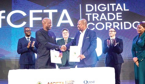 Wamkele Mene (left), Secretary-General, AfCFTA Secretariat, and Philip Gamey (right), Executive Chairman, QUEST Ghana, exchanging the signed agreement. Behind them are Pierre Laporte (middle), Minister for Finance, Economic Planning, Trade and Investment of Seychelles, and other dignitaries