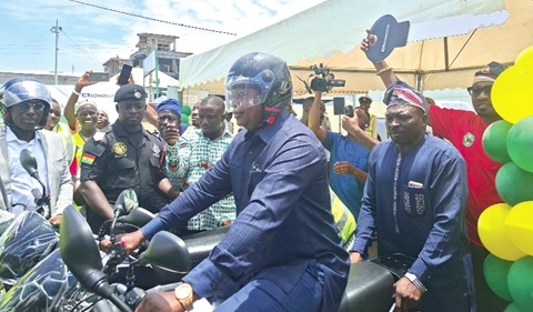 Joseph Bukari Nikpe, Minister of Transport, riding a motorcycle to symbolise the launch of the Safe Journey campaign by the NRSA