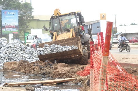 The contractor stabilising the excavated road section with boulders to prepare for the next phase of construction. Picture: ESTHER ADJORKOR ADJEI 