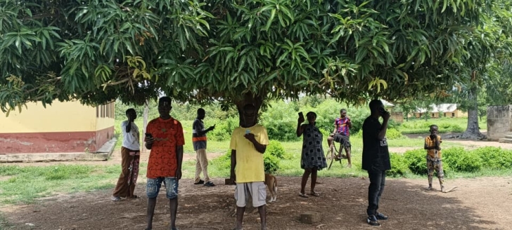 Residents have to gather under the mango tree for mobile network signal