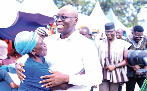 Dr Ato Forson, MP for Ajumako Anyan Assiam and the Minister of Finance, receives a warm embrace from a constituent