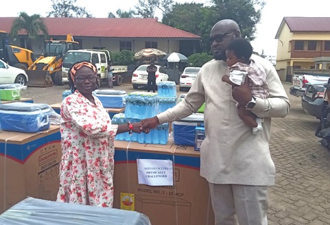 Mr Amoh Kamel (right), the Municipal Chief Executive for Asokwa, making a presentation to Miriam Okyere, a beneficiaryMr Amoh Kamel (right), the Municipal Chief Executive for Asokwa, making a presentation to Miriam Okyere, a beneficiary