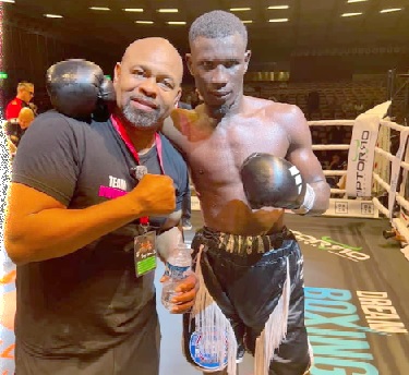 Faisal Abubakari in a memorable pose with former world champion Roy Jones Jr who worked the corner for Spomer