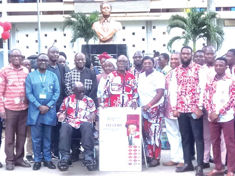 Prof. David Asamoah (2nd from left), Pro Vice-Chancellor, KNUST, together with Prof. Richard Kodzo Avugkah (holding citation), Unity Hall Master, Prof. John Owusu Addo (in wheelchair) and other attendees standing in front of the newly unveiled bust