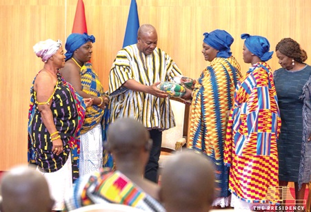 Some queenmothers from the Ahafo Region presenting a gift to President John Dramani Mahama (3rd from left), during the event