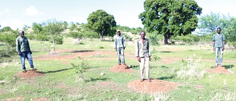 YAP personnel standing on the spots where the seedlings planted failed to survive YAP personnel standing on the spots where the seedlings planted failed to survive