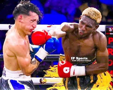 Theophilus Allotey (right), lands a jab to the face of Facundo David Garcia during the fight