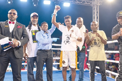 Referee Richard Amevi lifts Holy Dorgbetor's hand in to declare him winner of last Saturday's bout