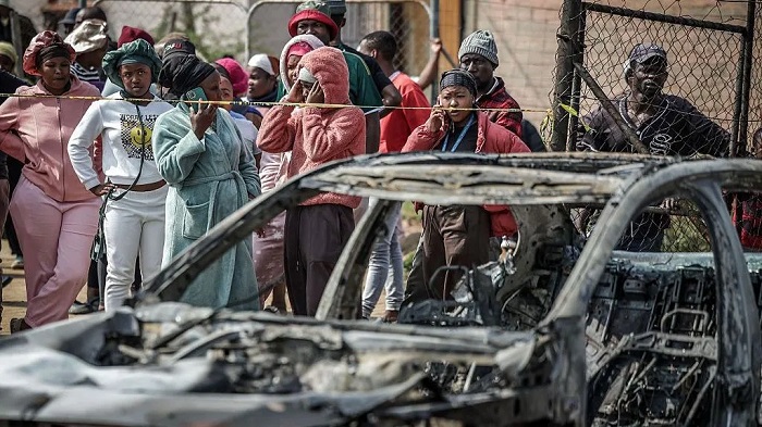 Gunmen torched vehicles as they fled the scene of a mass shooting at bar near Johannesburg