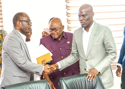 Haruna Iddrisu (right), Minister of Education, in a handshake with Prof. Ernest Kofi Davies (left), Director General, Ghana Education Service, after the meeting with the three-teacher unions. With them is Dr George Smith-Graham (middle), Chief Executive Officer, Fair Wages and Salaries Commission