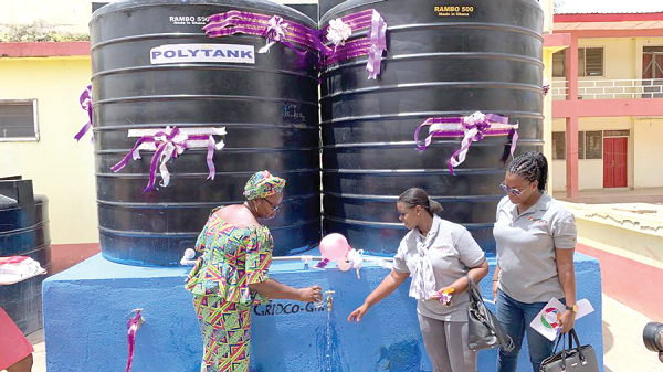 Mercy Babachuweh (left), Headmistress of NAVASCO, fetching the water to drink while Dzifa Bampoh and Millicent Atuguba of GRIDCO look on