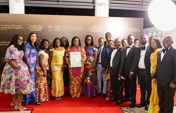 . Dr Ameh displaying her citation with some members of staff of The Trust Hospital