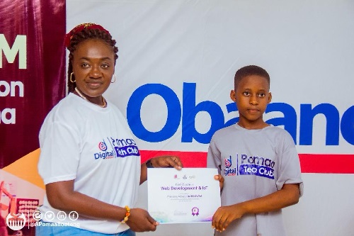 Member of Parliament for Juaben, Ama Pomaa Boateng presenting a certificate to one of the beneficiaries