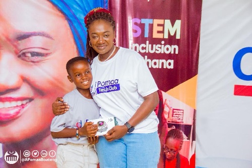 Member of Parliament for Juaben, Ama Pomaa Boateng presenting a prize to one of the beneficiaries