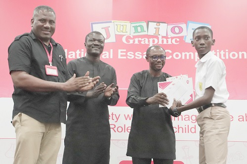 Stephen Kwaku Owusu (2nd from right), Deputy Director-General (Management Services), GES, presenting an award to Griffith Nana Osafo Brako (right), Winner of the 2023 Junior Graphic Essay Competition. Those with them are Franklin Sowa (left), Director Marketing and Sales, GCGL, and Victor Yaw Asante (2nd from left), MD of FBN Bank.