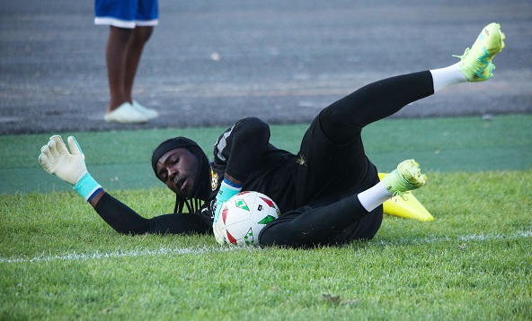 Lawrence Ati Zigi dives to make a save at training