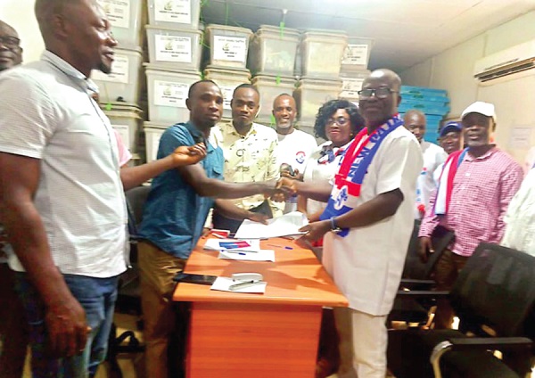 Alfred Obeng Boateng (right),  incumbent NPP MP for Bibiani-Anhwiaso-Bekwai, presenting his forms to Francis Addai Boateng, the Returning Officer at the district office of the EC