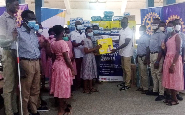 Mr Mensah (fourth from right) handing over the items to the school