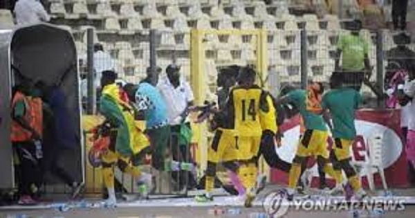 Black Stars players running to the dressing room after coming under attack during the pandemonium Black Stars players running to the dressing room after coming under attack during the pandemonium