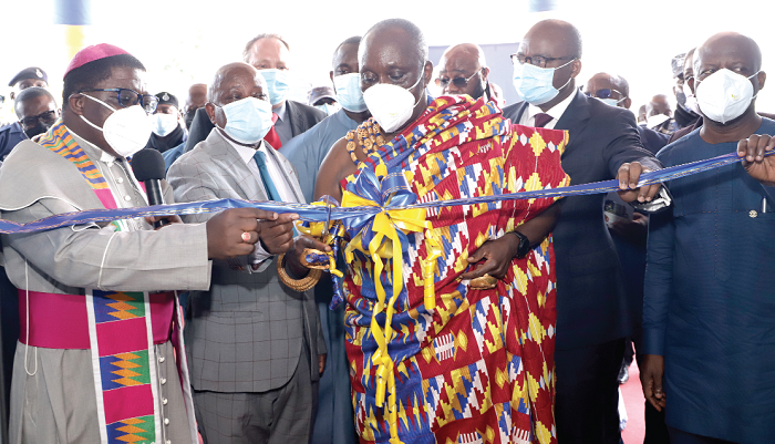 Nana Otuo Siriboe II (in Kente cloth), the Juabenhene and Chairman of the Council of State, being assisted by Dr Ernest Addison (right), Governor, Bank of Ghana; Mr Kwaku Agyeman-Manu (2nd left), Minister of Health, and the Most Reverend Dr Paul Kwabena Boafo (left), Presiding Bishop to Methodist Church of Ghana, to cut the tape to inaugurate the hospital. Pictures: EDNA SALVO-KOTEY