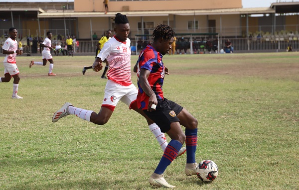 Michael Ampedu guards the ball away from his marker